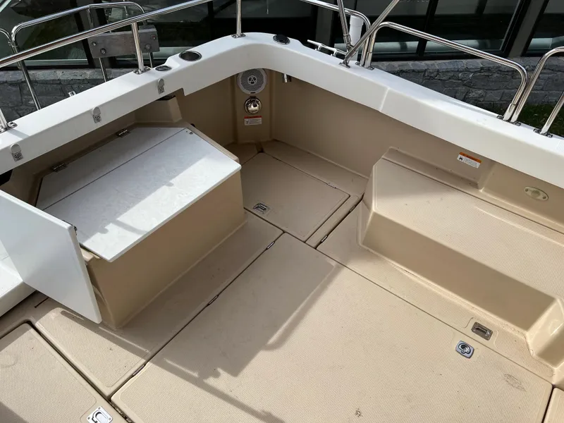 Slide: The Image of Spacious deck of 2013 Ranger Tugs R-27 boat with seating and storage. - 25