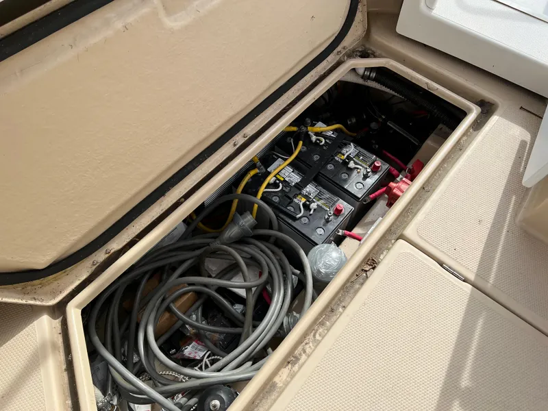 Slide: The Image of 2013 Ranger Tugs R-27 boat battery compartment with cables and wiring. - 26
