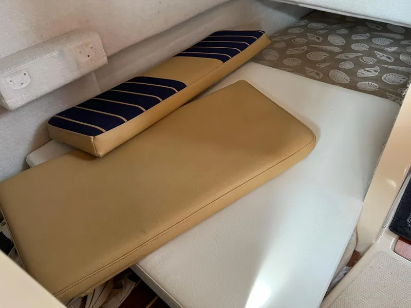 Slide: The Image of Interior cabin cushions of 2013 Ranger Tugs R-27 boat, featuring beige and striped designs. - 38