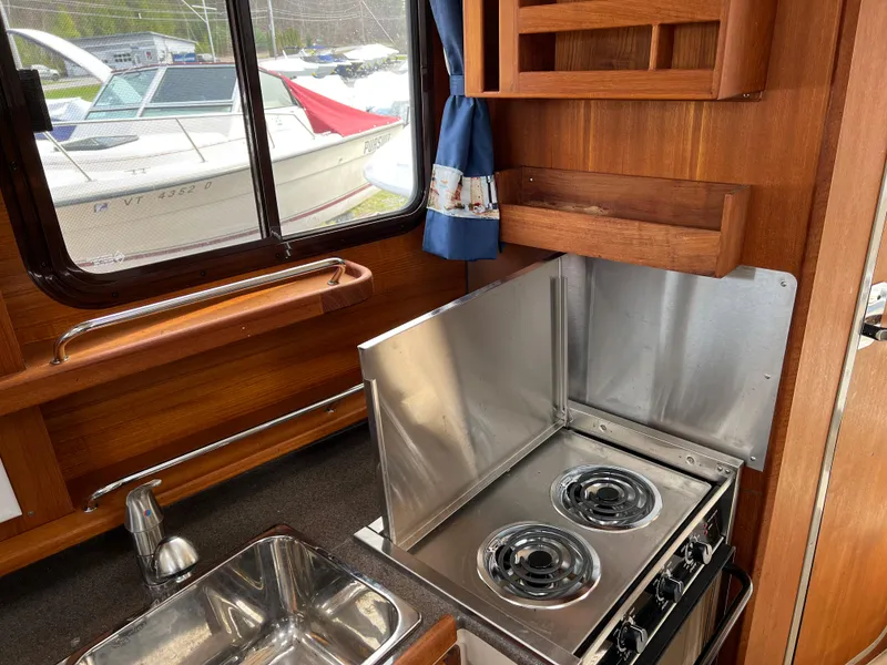Slide: The Image of 2013 Ranger Tugs R-27 boat kitchen with stove and sink. - 49
