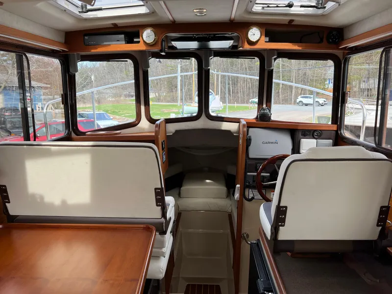 Slide: The Image of Interior of 2013 Ranger Tugs R-27 boat with wood accents and seating. - 55