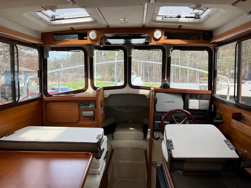 Slide: The Image of Interior of 2013 Ranger Tugs R-27 boat with wood finish and navigation equipment. - 56