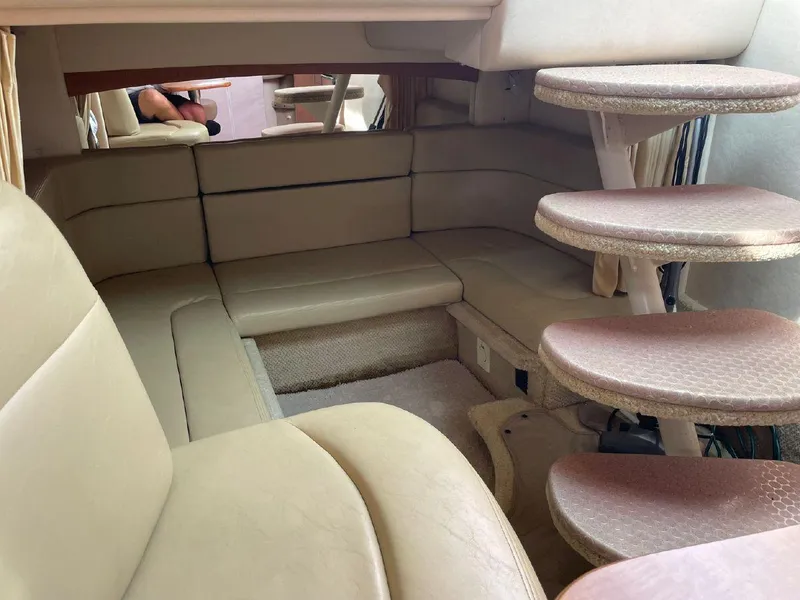 Slide: The Image of Interior of 2005 Sea Ray 320 Sundancer with beige leather seating and spiral staircase. - 12