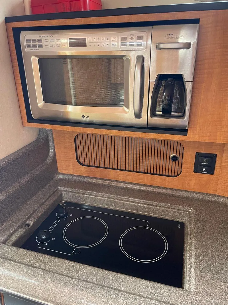 Slide: The Image of 2005 Sea Ray 320 Sundancer galley with microwave and stovetop - 13