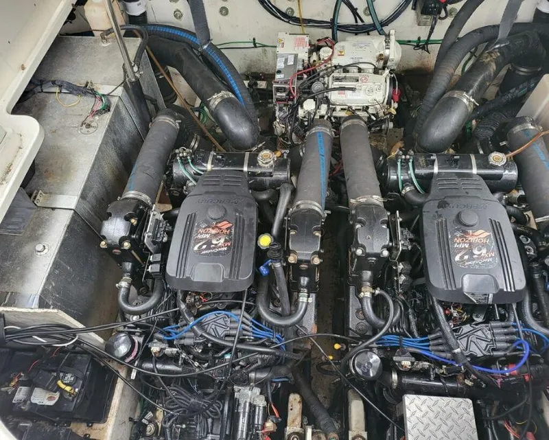 Slide: The Image of 2005 Sea Ray 320 Sundancer engine compartment with twin MerCruiser engines. - 15