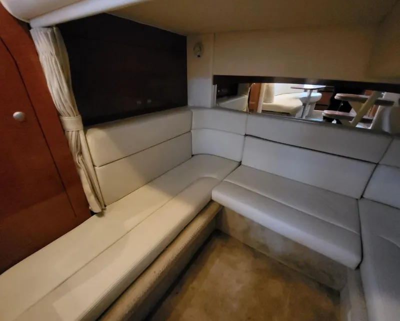Slide: The Image of Interior seating area of 2005 Sea Ray 320 Sundancer yacht with white leather upholstery. - 16