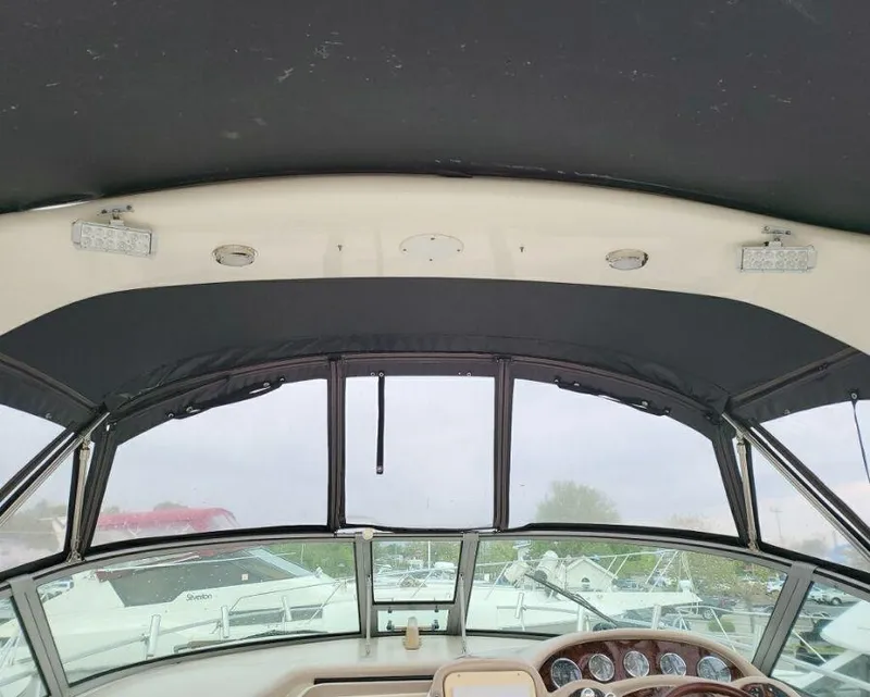 Slide: The Image of 2005 Sea Ray 320 Sundancer cockpit view with windshield and dashboard. - 17