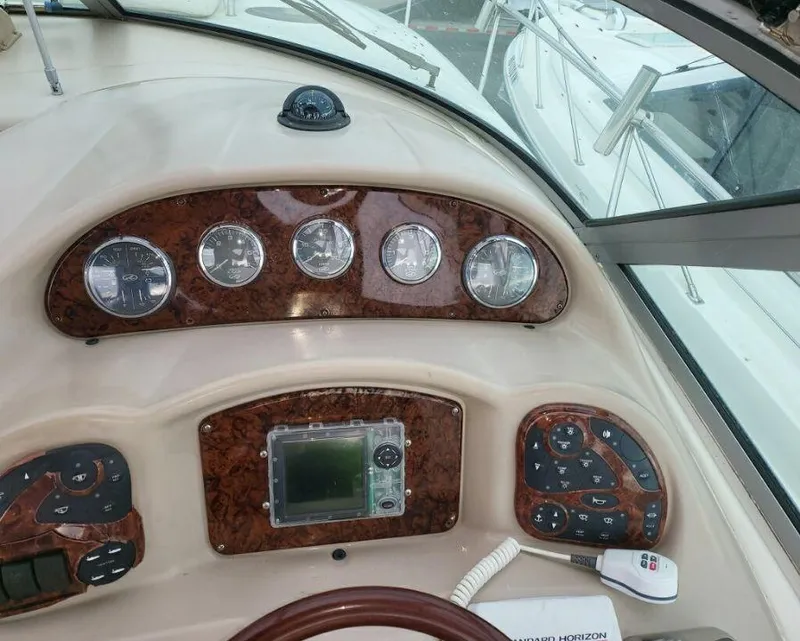 Slide: The Image of Control panel of a 2005 Sea Ray 320 Sundancer boat with gauges and navigation equipment. - 18