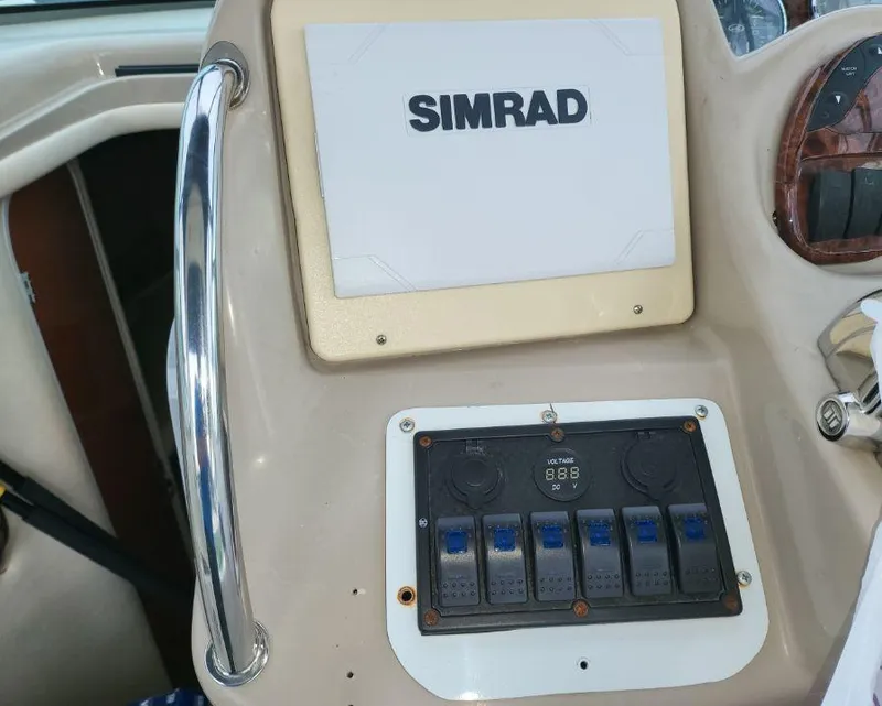 Slide: The Image of Control panel of a 2005 Sea Ray 320 Sundancer with Simrad display. - 19