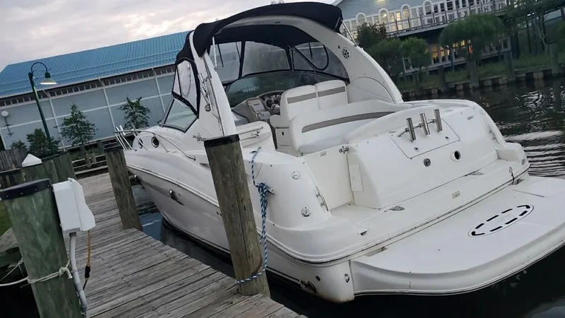 Slide: The Image of 2005 Sea Ray 320 Sundancer docked at a marina. - 2