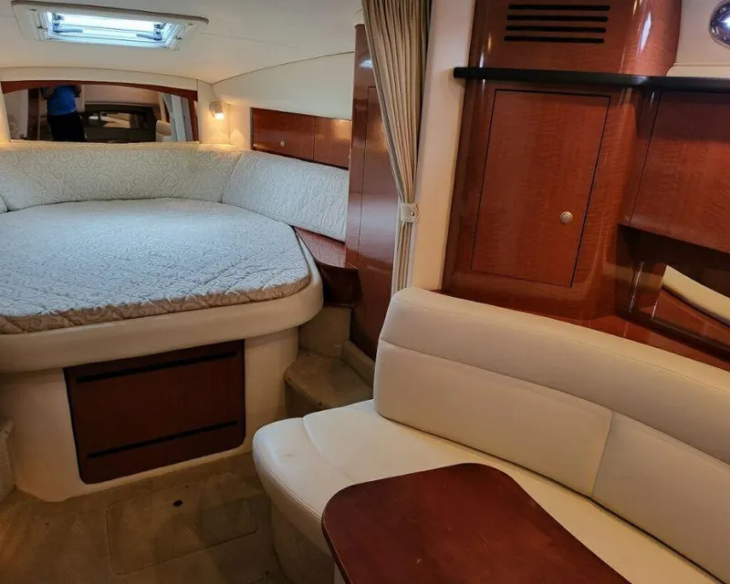 Slide: The Image of Interior cabin of a 2005 Sea Ray 320 Sundancer yacht with bed and seating area. - 21