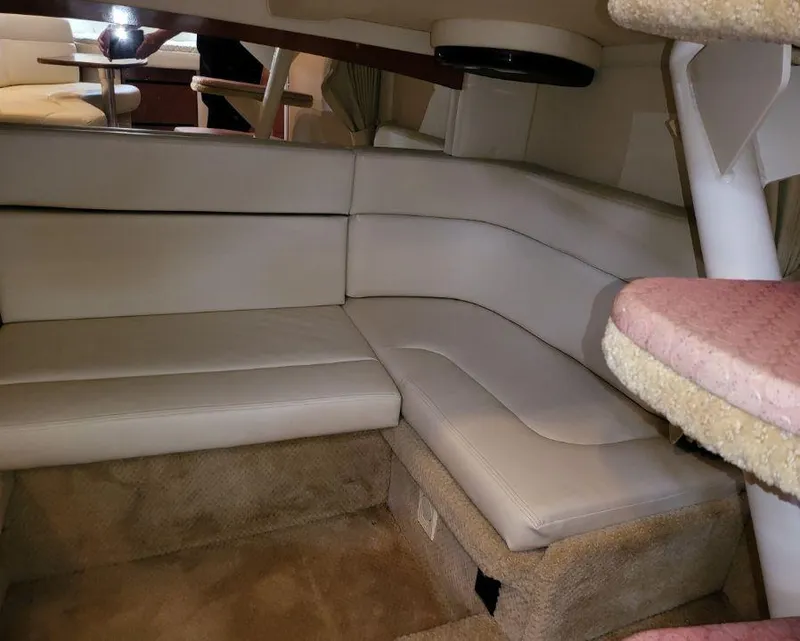 Slide: The Image of Interior seating area of 2005 Sea Ray 320 Sundancer yacht with beige upholstery. - 23