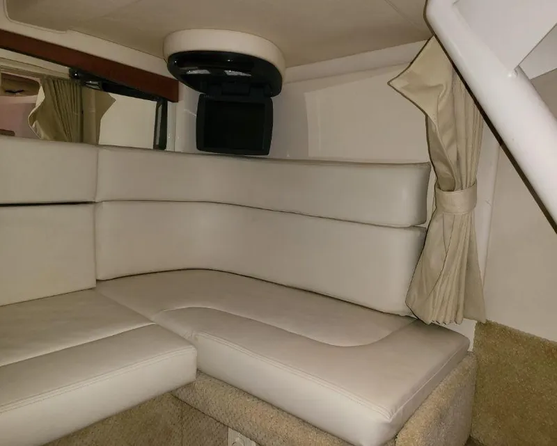 Slide: The Image of Interior cabin of 2005 Sea Ray 320 Sundancer with beige leather seating. - 24