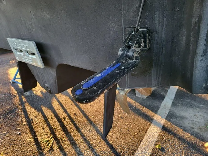 Slide: The Image of Trim tab of a 2005 Sea Ray 320 Sundancer boat in a parking lot. - 28