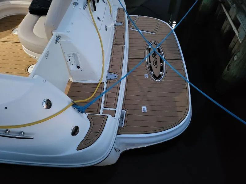 Slide: The Image of 2005 Sea Ray 320 Sundancer boat stern with teak deck and mooring lines. - 37
