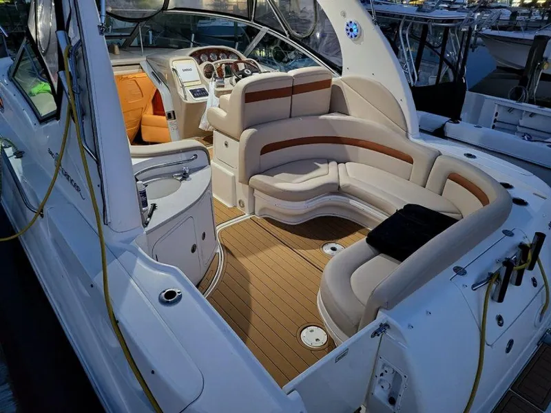 Slide: The Image of 2005 Sea Ray 320 Sundancer boat interior with seating and helm station. - 39