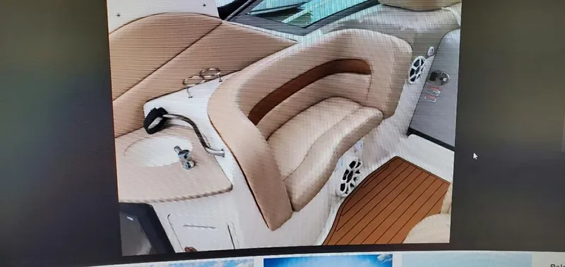 Slide: The Image of Interior seating of a 2005 Sea Ray 320 Sundancer boat with beige upholstery. - 7