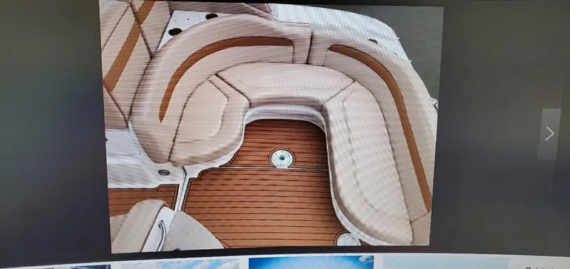Slide: The Image of 2005 Sea Ray 320 Sundancer boat interior with cushioned seating and teak flooring. - 9