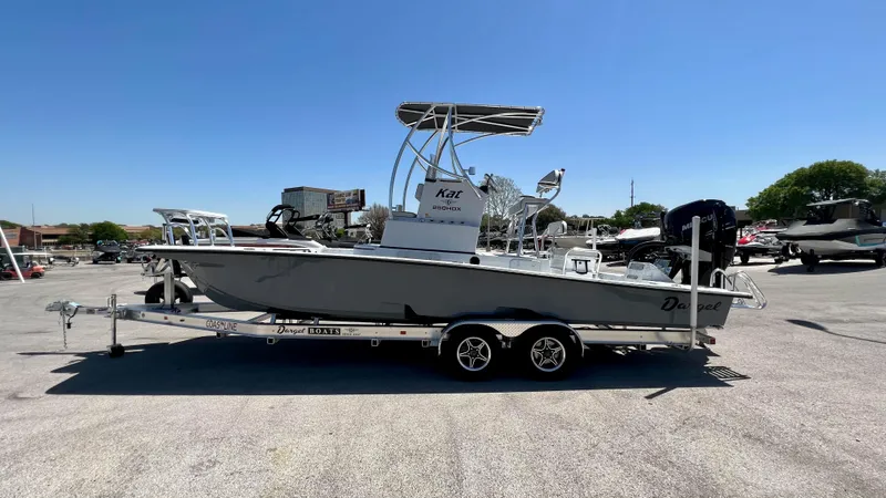 Slide: The Image of 2023 Dargel KAT 250 DX boat on a trailer in a parking lot. - 2