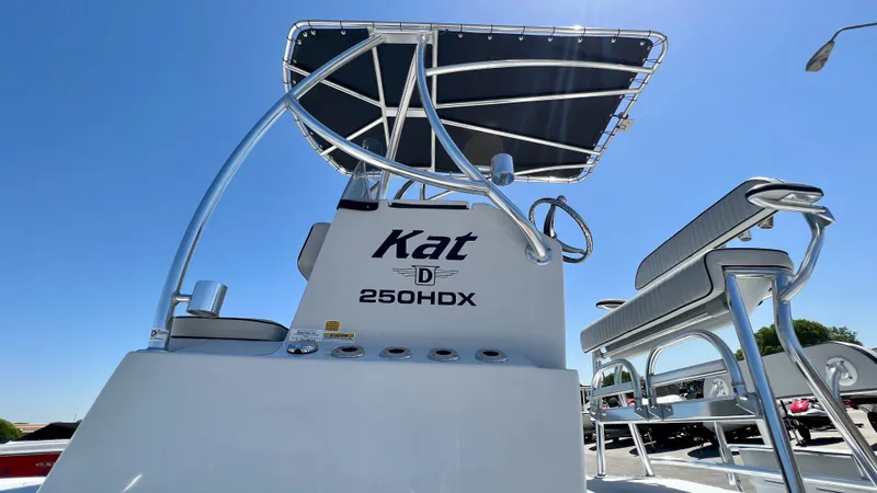 Slide: The Image of 2023 Dargel KAT 250 DX boat console and seating under a clear blue sky. - 20