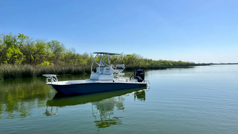 Slide: The Image of 2023 Dargel KAT 250 DX boat on calm lake waters. - 25