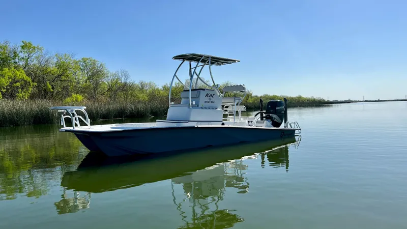 Slide: The Image of 2023 Dargel KAT 250 DX boat on calm water with clear blue sky. - 32