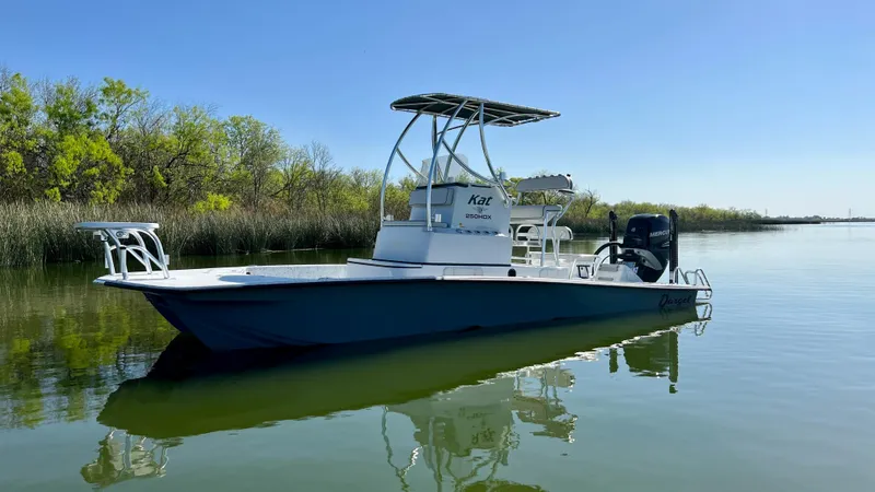 Slide: The Image of 2023 Dargel KAT 250 DX boat on calm water with clear blue sky. - 35