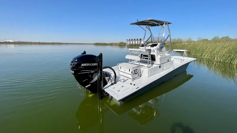 Slide: The Image of 2023 Dargel KAT 250 DX boat on calm water with Mercury outboard motor. - 39