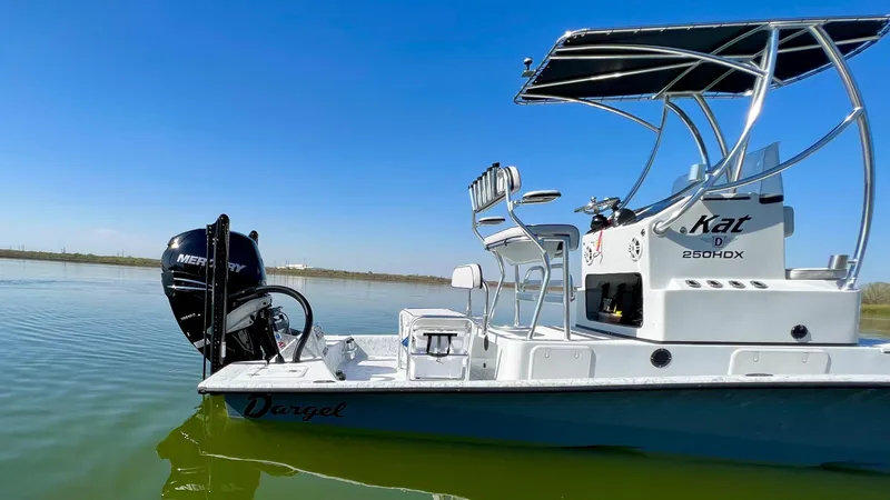 Slide: The Image of 2023 Dargel KAT 250 DX boat on calm water with Mercury outboard motor. - 41