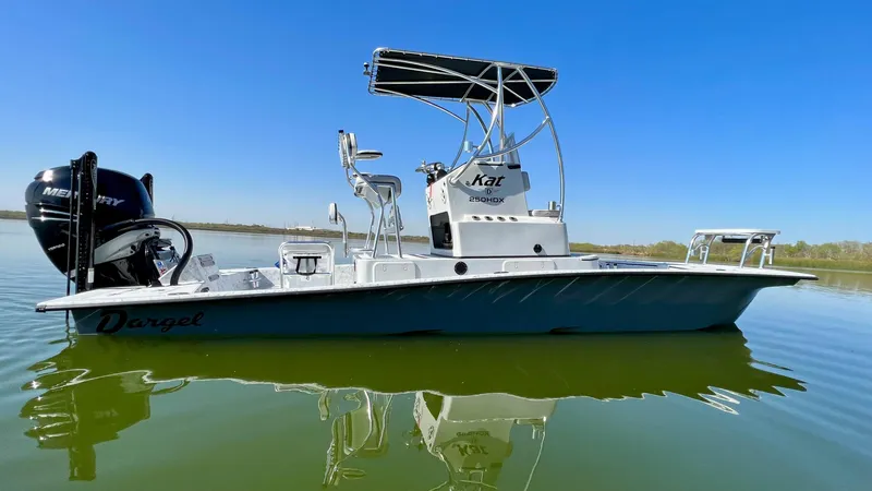 Slide: The Image of 2023 Dargel KAT 250 DX boat on calm water with clear blue sky. - 45