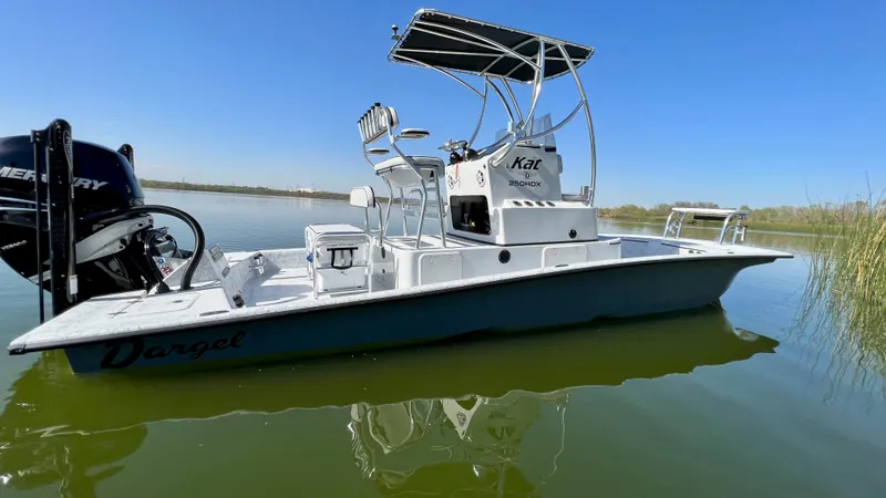 Slide: The Image of 2023 Dargel KAT 250 DX boat on calm water with clear blue sky. - 46