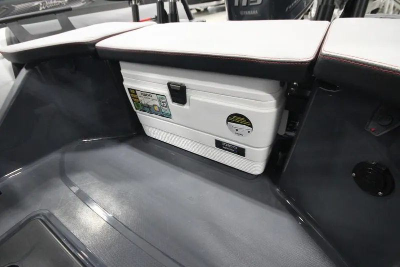 Slide: The Image of 2023 Zodiac Open 5.5 PVC T-Top 115hp boat interior with storage compartment. - 7