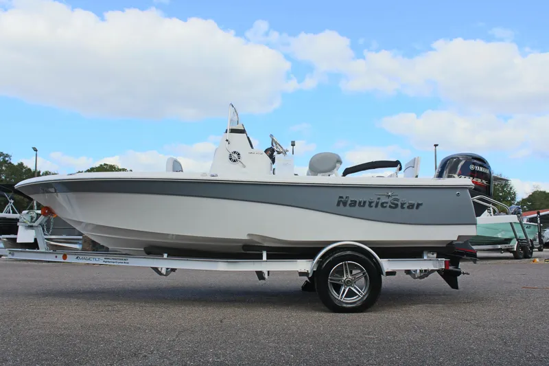 The Image of 2022 NauticStar 195 XTS boat on trailer under blue sky. - 1
