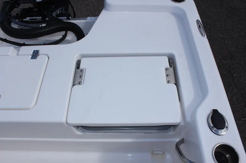 Slide: The Image of 2022 NauticStar 195 XTS boat deck with storage compartment and cup holders. - 13