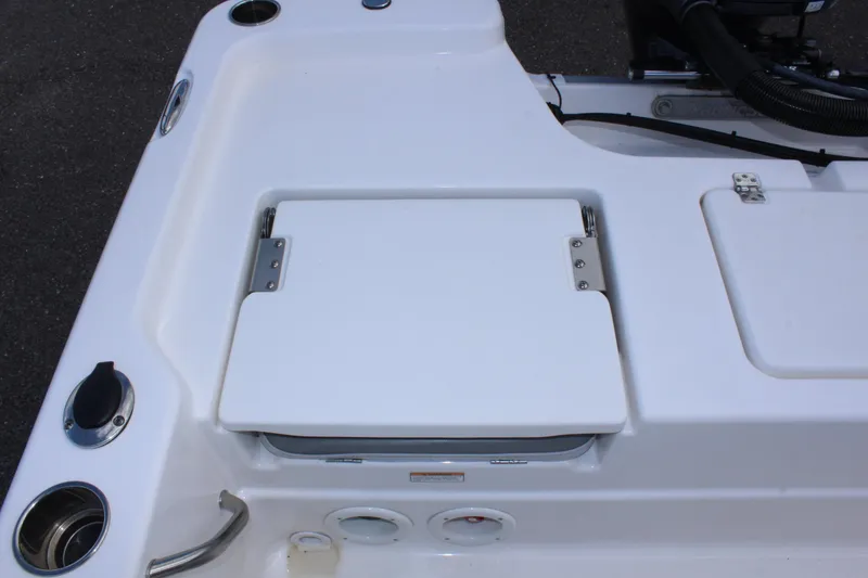 Slide: The Image of 2022 NauticStar 195 XTS boat deck with storage compartment and cup holders. - 17