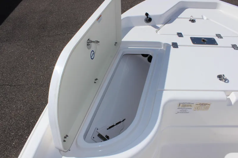 Slide: The Image of 2022 NauticStar 195 XTS boat storage compartment open on deck. - 24