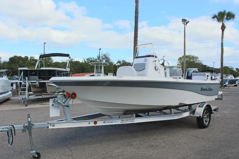 Slide: The Image of 2022 NauticStar 195 XTS boat on trailer, parked outdoors under cloudy sky. - 3