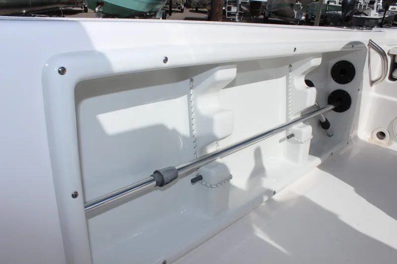 Slide: The Image of 2022 NauticStar 195 XTS boat interior detail with rod holder and storage compartment. - 34