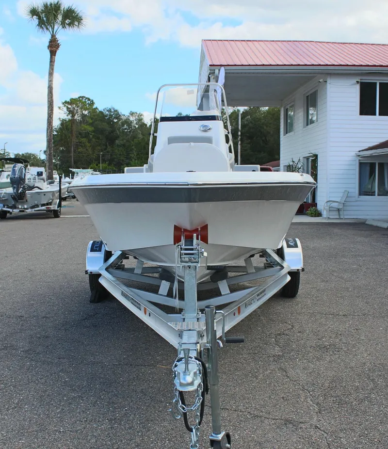 Slide: The Image of 2022 NauticStar 195 XTS boat on trailer, parked outside a building. - 4