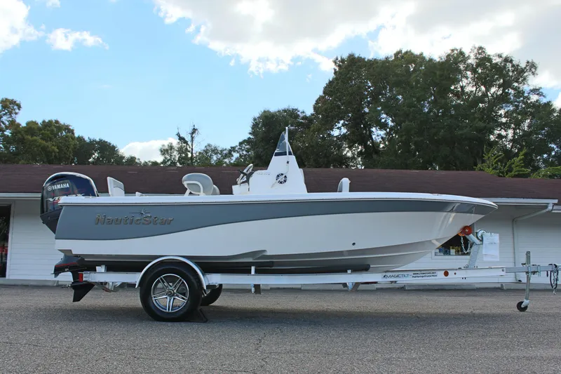 Slide: The Image of 2022 NauticStar 195 XTS boat on trailer, parked outdoors. - 7