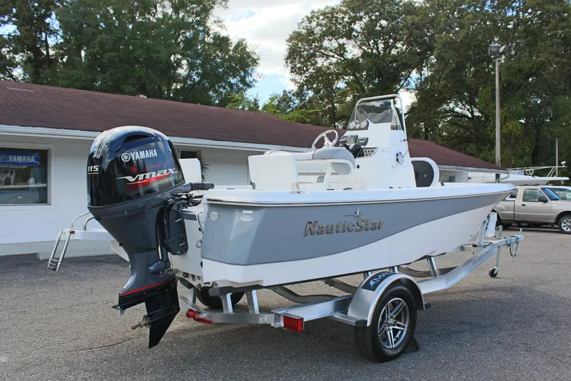 Slide: The Image of 2022 NauticStar 195 XTS boat with Yamaha engine on trailer, parked outdoors. - 8