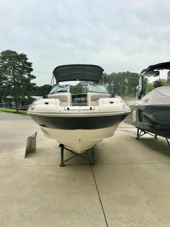 Slide: The Image of 2003 Sea Ray 240 Sundeck boat on display, front view, outdoors. - 1