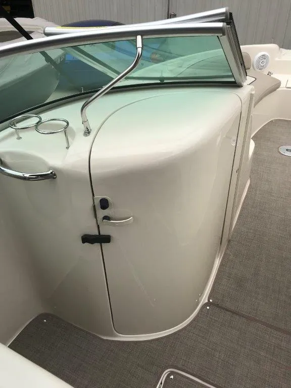 Slide: The Image of 2003 Sea Ray 240 Sundeck interior with windshield and door, featuring sleek design elements. - 10