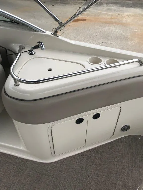 Slide: The Image of 2003 Sea Ray 240 Sundeck interior with sink and cup holders. - 13