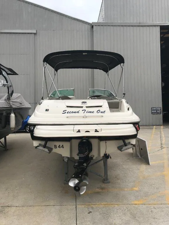 Slide: The Image of 2003 Sea Ray 240 Sundeck boat in storage, rear view with canopy. - 18