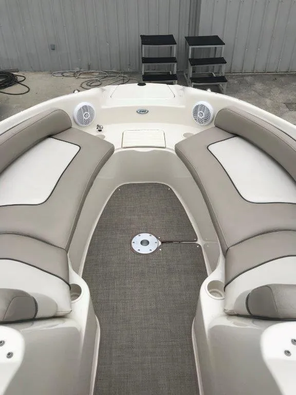 Slide: The Image of 2003 Sea Ray 240 Sundeck interior with beige seating and carpeted floor. - 3