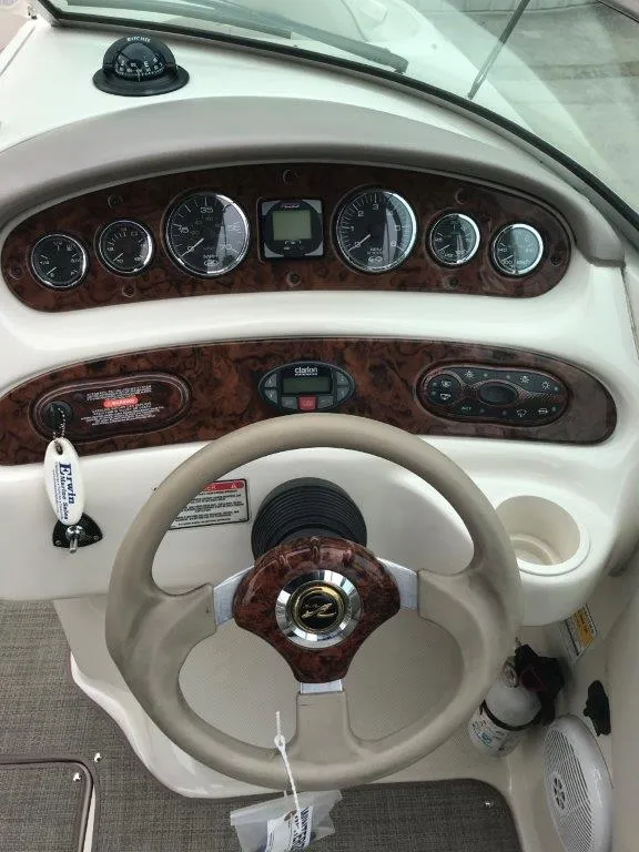 Slide: The Image of Dashboard of a 2003 Sea Ray 240 Sundeck boat with steering wheel and gauges. - 6
