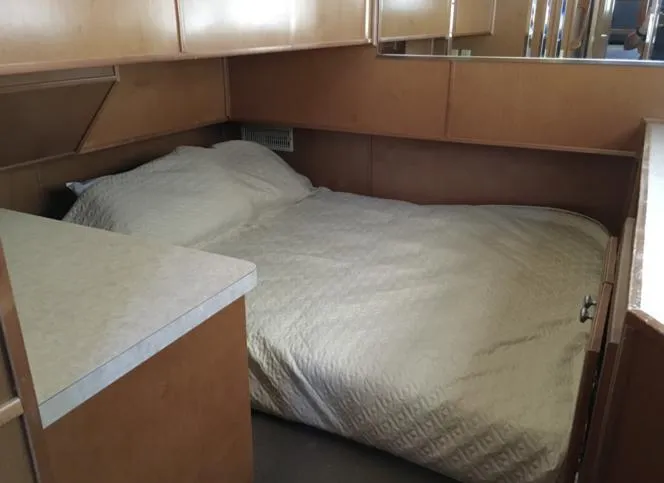 Slide: The Image of 2004 Sumerset Kapalua Share #13 houseboat bedroom with double bed and wooden cabinetry. - 10