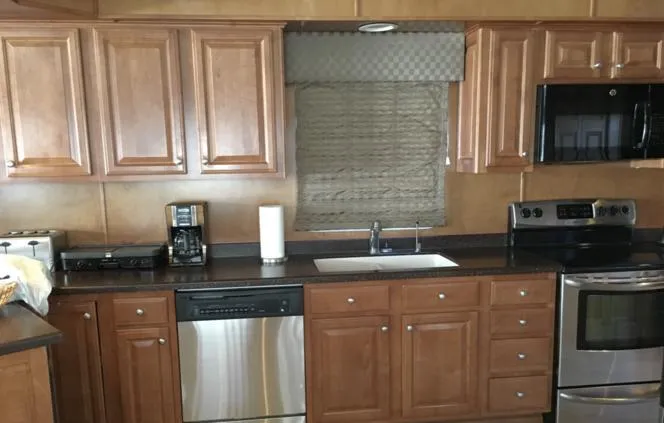 Slide: The Image of 2004 Sumerset Kapalua Share #13 kitchen with wooden cabinets and stainless steel appliances. - 12