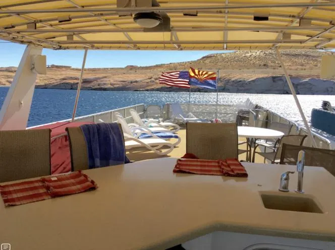 Slide: The Image of 2004 Sumerset Kapalua Share #13 houseboat deck with seating, towels, and scenic lake view. - 14